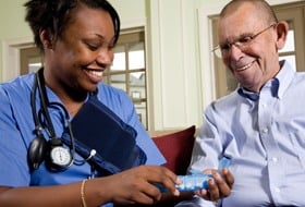 A nurse teaching a patient about his medicine.