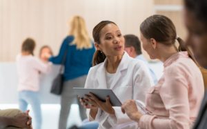 Medical Assistant Smiling With Patient