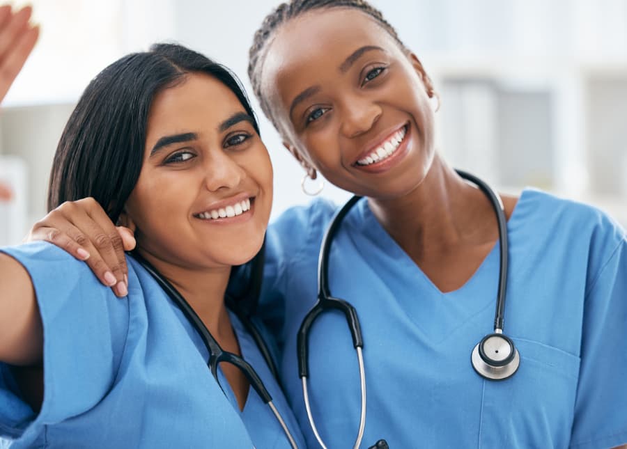 Nurses taking a picture while smiling and wearing stethoscopes